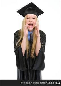 Happy young woman in graduation gown shouting through megaphone