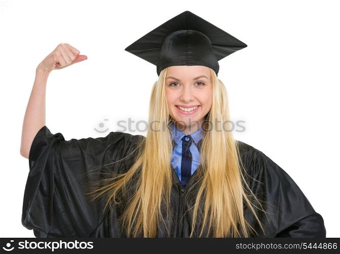 Happy young woman in graduation gown showing biceps