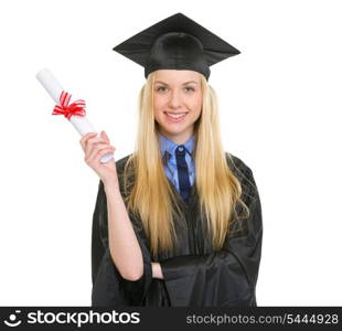 Happy young woman in graduation gown showing diploma