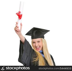 Happy young woman in graduation gown with diploma rejoicing success