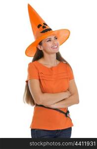 Happy young woman in Halloween hat looking on copy space