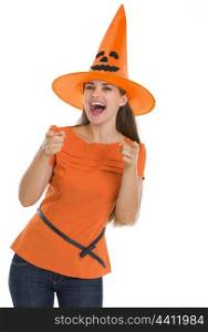 Happy young woman in Halloween hat pointing on you