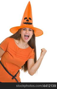 Happy young woman in Halloween hat showing yes gesture