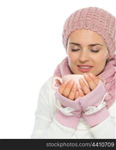 Happy young woman in knit winter clothing enjoying cup of hot coffee