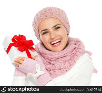 Happy young woman in knit winter clothing holding Christmas present box