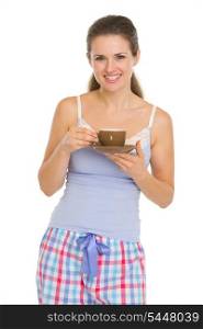 Happy young woman in pajamas after sleep with cup of coffee