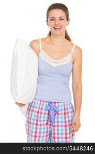 Happy young woman in pajamas holding pillow