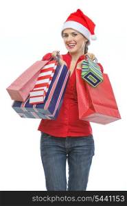 Happy young woman in Santa hat holding shopping bags