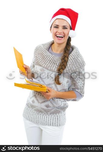 Happy young woman in sweater and christmas hat holding christmas mails