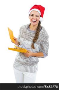 Happy young woman in sweater and christmas hat holding christmas mails