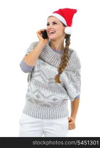 Happy young woman in sweater and christmas hat talking cell phone