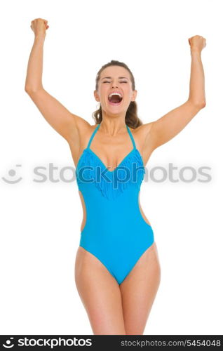 Happy young woman in swimsuit and hat rejoicing success