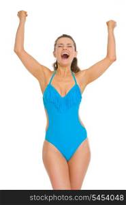 Happy young woman in swimsuit and hat rejoicing success