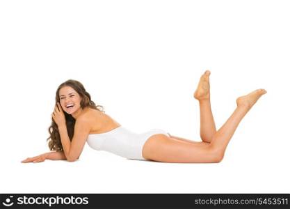 Happy young woman in swimsuit laying on floor