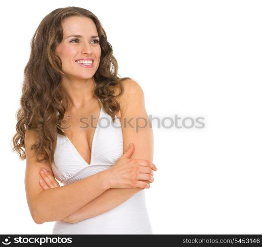 Happy young woman in swimsuit looking on copy space