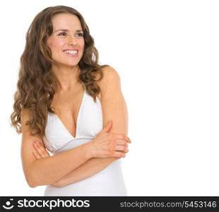 Happy young woman in swimsuit looking on copy space