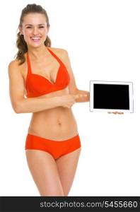 Happy young woman in swimsuit pointing on tablet pc blank screen