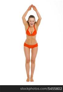 Happy young woman in swimsuit ready to jump in water