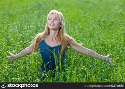 happy young woman in the field of green ears