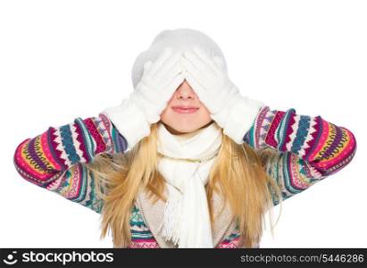Happy young woman in winter clothes closing eyes