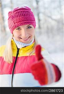 Happy young woman in winter clothing outdoors