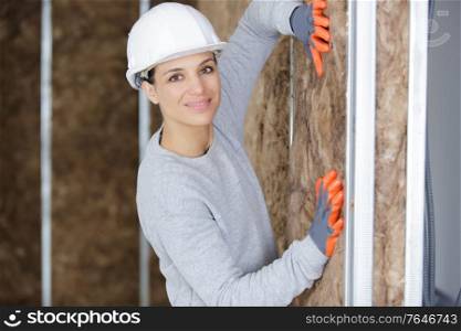 happy young woman is insulating wall