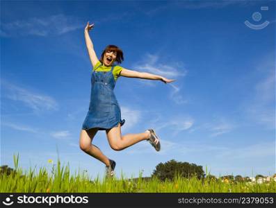 Happy young woman jumping and enjoying the spring on a beautiful day