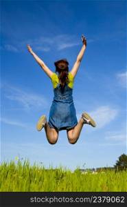 Happy young woman jumping and enjoying the spring on a beautiful day