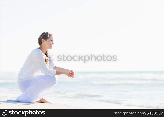 Happy young woman looking at sea