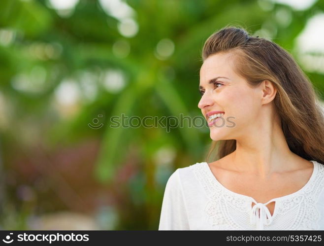 Happy young woman looking on copy space