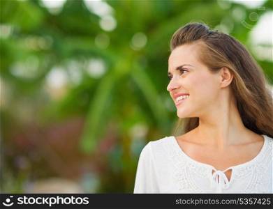 Happy young woman looking on copy space