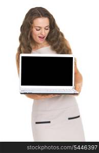 Happy young woman looking on laptop blank screen