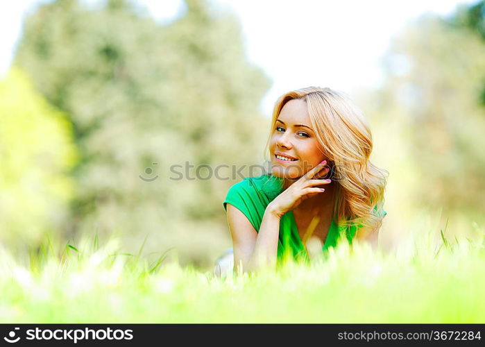 Happy young woman lying on grass