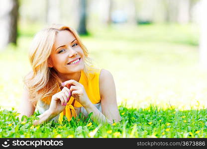 Happy young woman lying on grass