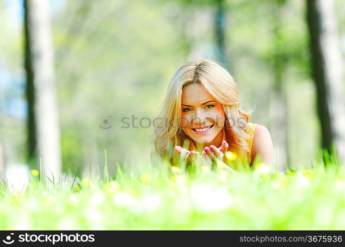 Happy young woman lying on grass