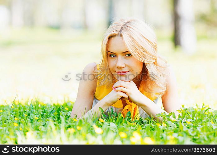 Happy young woman lying on grass