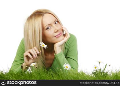 Happy young woman lying on grass with chamomile flowers, isolated on white background