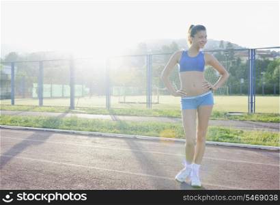 happy young woman on athletic race track relax