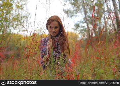happy young woman outdoors in the field in autumn