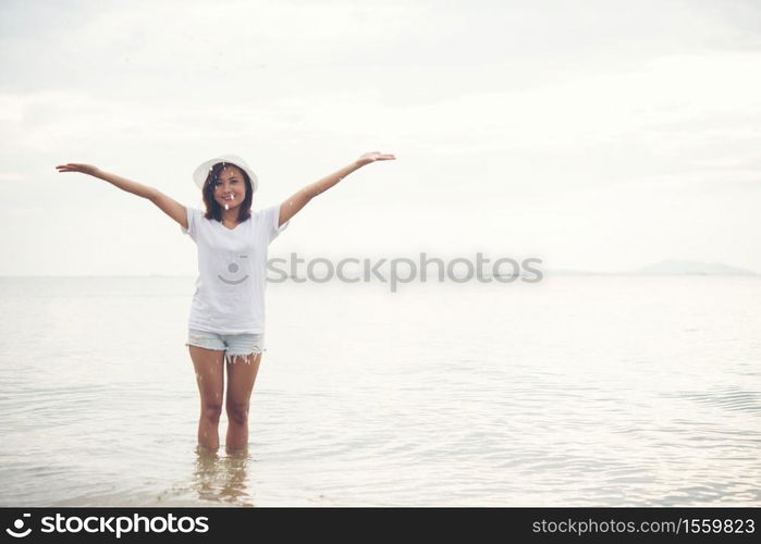 Happy young woman playing on beach at the vacation time.