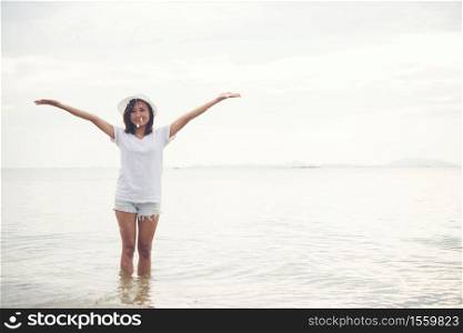 Happy young woman playing on beach at the vacation time.