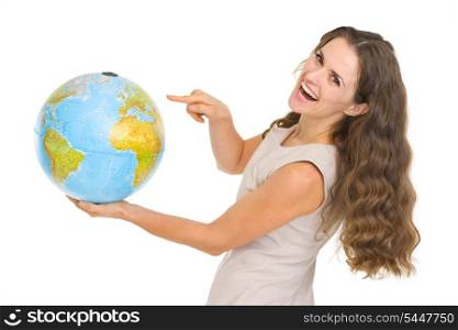 Happy young woman pointing on globe