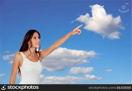 Happy young woman pointing something with a blue sky of background