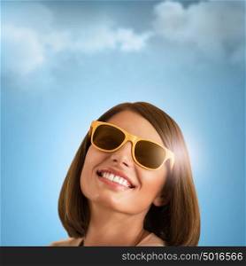 Happy young woman posing over blue sky