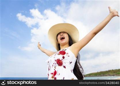 happy young woman raised hands on the beach