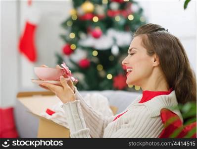 Happy young woman received parcel with Christmas gift