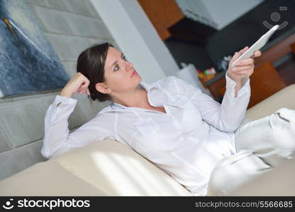 happy young woman relax at home on sofa in bright living room and watching tv