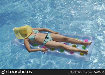 happy young woman relax at swimming pool at vacation travel resort