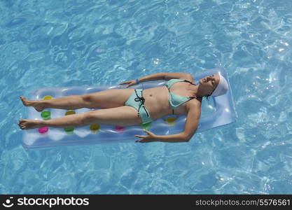 happy young woman relax at swimming pool at vacation travel resort