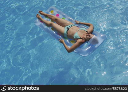 happy young woman relax at swimming pool at vacation travel resort